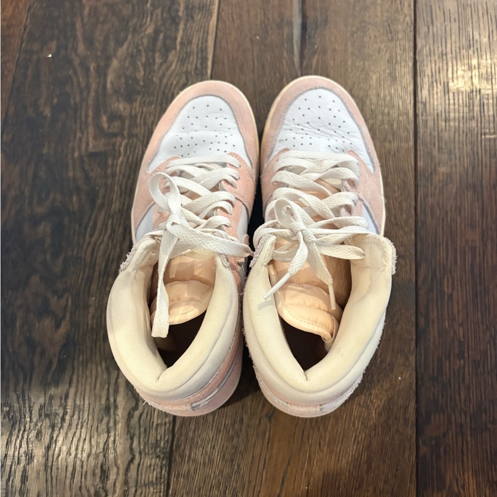Women’s pink and creme Nike high tops